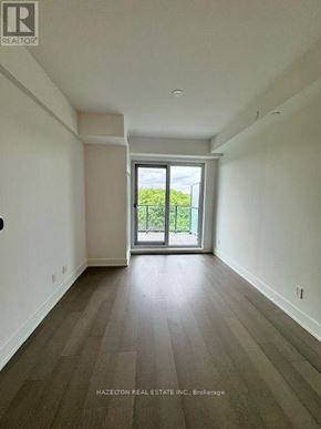 Toronto (Yonge-Eglinton) condo for rent - A room with a view of a green landscape through a glass door.