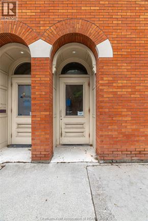 Chatham apartment for rent - A red brick building with a white door and window.