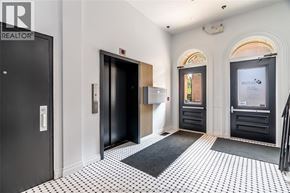 Chatham apartment for rent - A hallway with black and white tiled floors and a black door on the left.