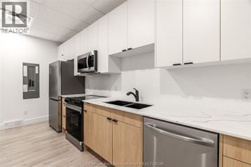 Chatham apartment for rent - A kitchen with white cabinets and a stainless steel dishwasher.