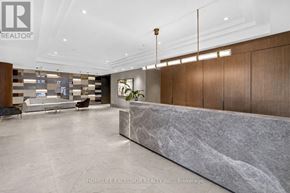 Kitchener condo for rent - A spacious lobby with marble floors and wooden paneling.