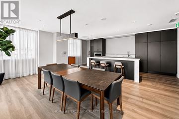 Kitchener condo for rent - A modern dining room with a wooden table and chairs.