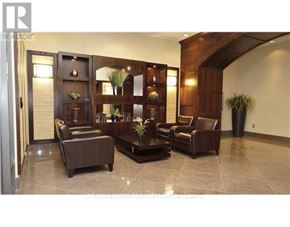 Ottawa condo for rent - A living room with a brown leather couch and a wooden cabinet.