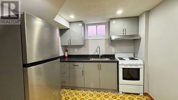 Mississauga (Lakeview) apartment for rent - A small kitchen with a refrigerator, oven, and sink.