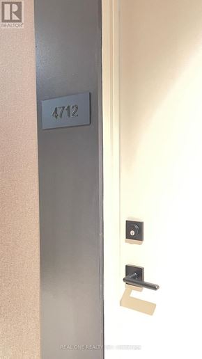 Toronto (Waterfront Communities) condo for rent - A door with a number plate on it and a Realty logo.
