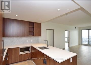 Toronto (Bayview Village) condo for rent - A modern kitchen with wooden cabinets and a marble countertop.