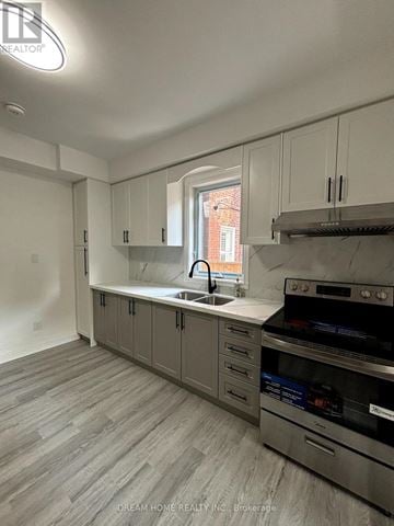 Toronto (Palmerston-Little Italy) apartment for rent - A kitchen with a stove top oven and a sink.