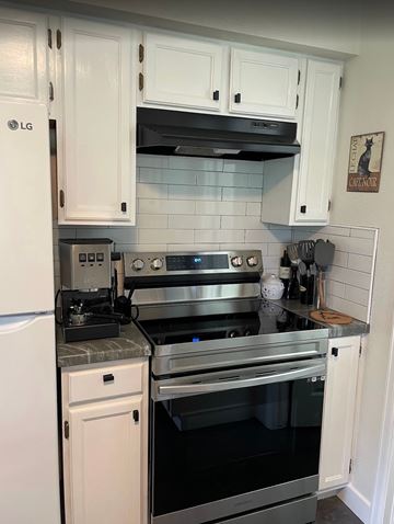Boulder apartment for rent - A kitchen with a stove top oven and a refrigerator.