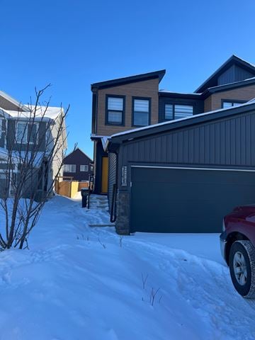 Edmonton apartment for rent - A red car is parked in front of a garage.