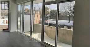 Burlington (Lasalle) condo for rent - A view from inside a building looking out through a large glass window.