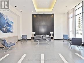 Mississauga (City Centre) condo for rent - A modern waiting room with a large painting on the wall and comfortable seating.