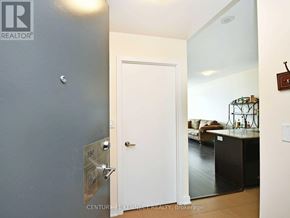 Mississauga (City Centre) condo for rent - A white door with a silver handle is in a room with a grey wall.