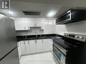 Toronto (Blake-Jones) apartment for rent - A modern kitchen with black appliances and white cabinets.