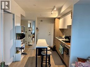 Toronto condo for rent - A kitchen with a table and chairs in the middle of the room.