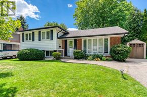 Burlington (Appleby) apartment for rent - A house with a white garage door and a brick chimney.