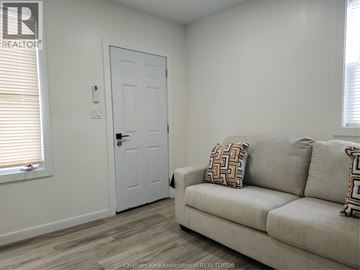 Chatham apartment for rent - A living room with a couch and a door.