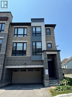 Whitby (Port Whitby) townhouse for rent - A modern two-story building with a garage is for sale.