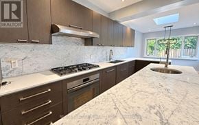 Toronto (Leaside) apartment for rent - A kitchen with a marble countertop and a stainless steel stove.