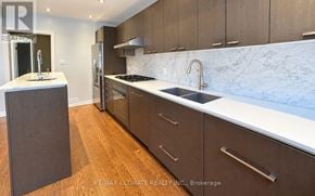 Toronto (Leaside) apartment for rent - A kitchen with a marble countertop and wooden cabinets.