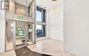 Hamilton (Riverdale) condo for rent - A brokerage office with a glass door entrance and a chandelier hanging from the ceiling.