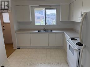 Welland (N. Welland) townhouse for rent - A kitchen with white appliances and cabinets.