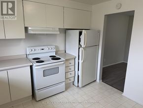Welland (N. Welland) townhouse for rent - A kitchen with white appliances and cabinets.