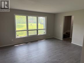 Welland (N. Welland) townhouse for rent - A room with a large window and wooden flooring.