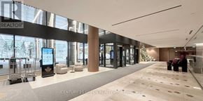 Toronto (Waterfront Communities) condo for rent - A lobby with a Christmas tree and a sign that says Century 21 Green Realty.