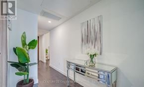Toronto (Waterfront Communities) condo for rent - A room with a painting on the wall and a plant on the floor.