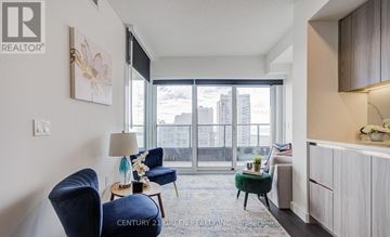 Toronto (Waterfront Communities) condo for rent - A living room with a blue chair and a white couch.
