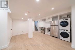 Toronto (Corso Italia-Davenport) apartment for rent - A spacious room with a washer and dryer stacked on top of each other.