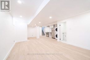 Toronto (Corso Italia-Davenport) apartment for rent - A spacious room with wooden flooring and white walls, furnished with a kitchenette.