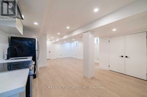 Toronto (Corso Italia-Davenport) apartment for rent - A spacious room with a television and white cabinets.
