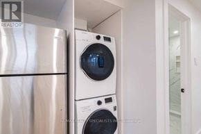 Toronto (Corso Italia-Davenport) apartment for rent - A stack of white washers and dryers in a small laundry room.