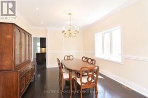Mississauga (Central Erin Mills) apartment for rent - A dining room with a wooden table and chairs.