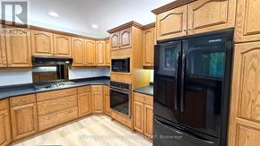 London North (North K) apartment for rent - A kitchen with wooden cabinets and black appliances.