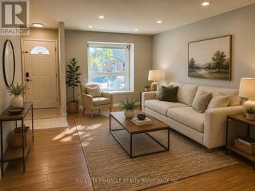 London East (East H) townhouse for rent - A living room with a couch, chair, and table.