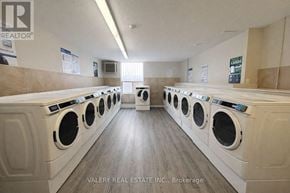 Toronto (Crescent Town) condo for rent - A laundromat with rows of washers and dryers.