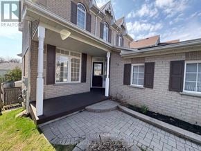 Oshawa (Pinecrest) apartment for rent - A house with a front porch and a black door.