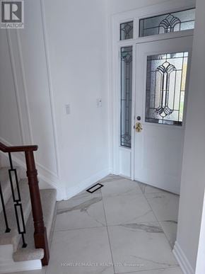 Oshawa (Pinecrest) apartment for rent - A white door with a glass panel and a wooden staircase.