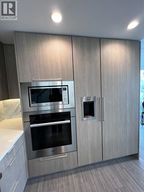 Burnaby apartment for rent - A modern kitchen with a stainless steel oven and microwave.