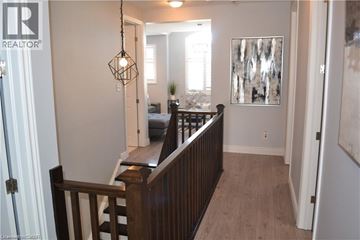 Kitchener apartment for rent - A living room with a couch and a painting on the wall.