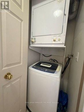 Toronto (Willowdale West) condo for rent - A white washing machine and dryer in a small laundry room.