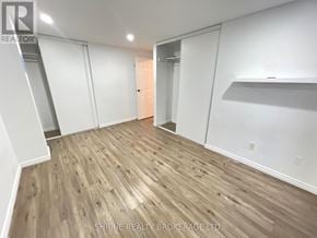 London South (South P) townhouse for rent - A room with wooden flooring and white walls, with a door in the background.