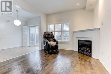 Markham (Village Green-South Unionville) apartment for rent - A living room with a black chair and a fireplace.