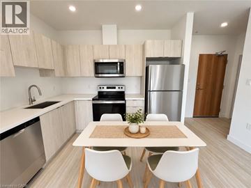 Cambridge condo for rent - A modern kitchen with a table and chairs in the foreground.