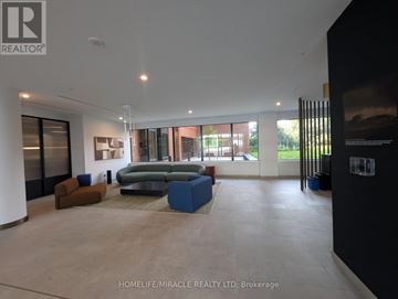 Toronto (Banbury-Don Mills) condo for rent - A spacious living room with a large sofa and a coffee table.