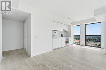 Toronto (Thorncliffe Park) condo for rent - A real estate listing image of a white room with a kitchen area and a view of the city.