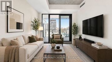 Toronto (Moss Park) condo for rent - A living room with a couch, a coffee table, and a flat screen TV mounted on the wall.