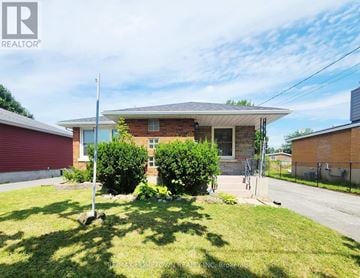 Cornwall apartment for rent - A house with a red garage door is for sale.
